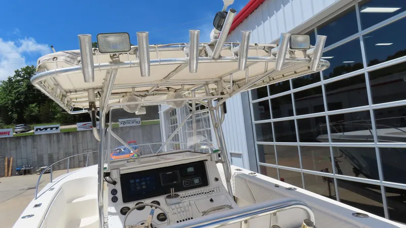 Slide: The Image of 2002 Fountain 38 TE boat with control panel and rod holders, docked near a building. - 13