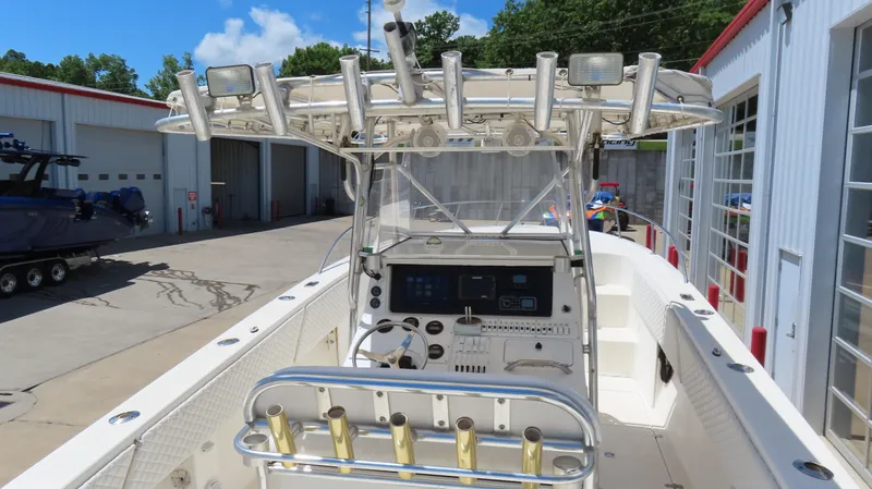 Slide: The Image of 2002 Fountain 38 TE boat with center console and rod holders, docked at a marina. - 14