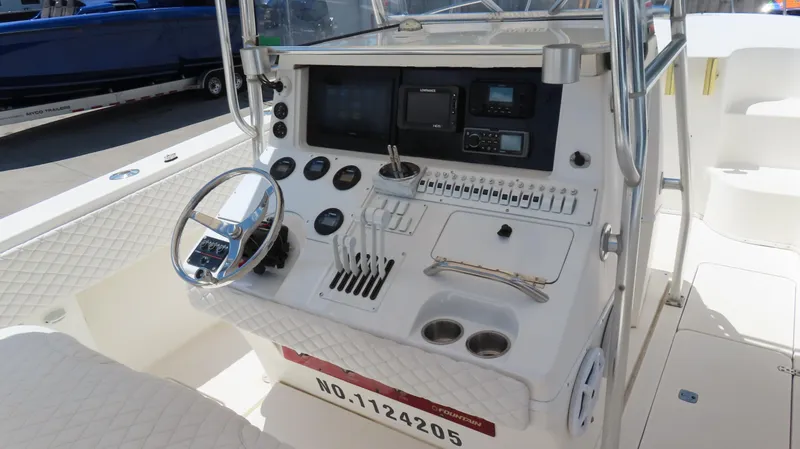 Slide: The Image of 2002 Fountain 38 TE boat dashboard with steering wheel and control panel. - 15