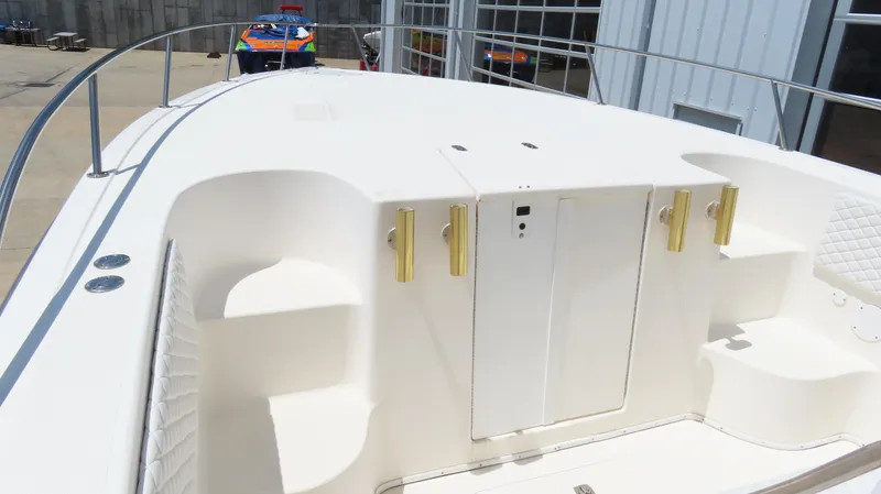 Slide: The Image of 2002 Fountain 38 TE boat deck with white seating and storage compartments. - 19