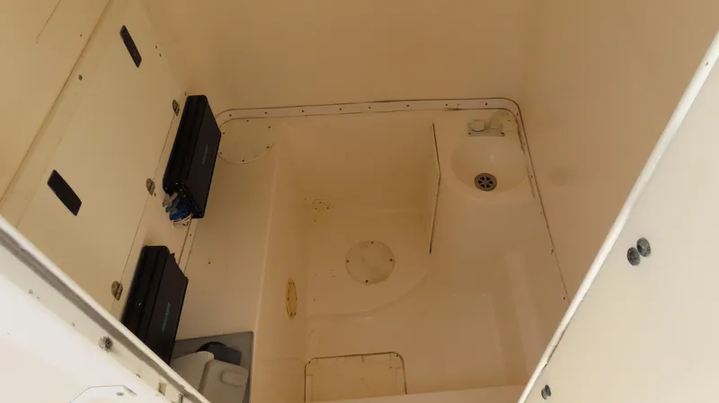 Slide: The Image of 2002 Fountain 38 TE boat interior compartment with storage and drainage features. - 21