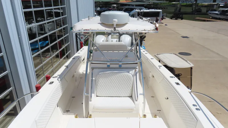 Slide: The Image of 2002 Fountain 38 TE boat with center console and seating, docked near a marina. - 23