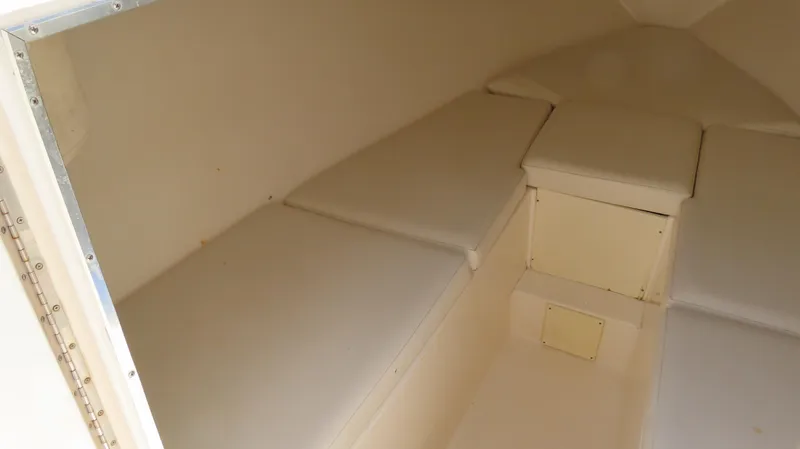 Slide: The Image of 2002 Fountain 38 TE boat interior cabin with cushioned seating and storage. - 25