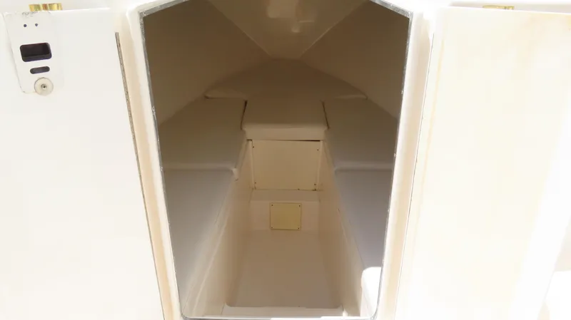 Slide: The Image of Interior cabin of a 2002 Fountain 38 TE boat, featuring a compact, minimalist design. - 27