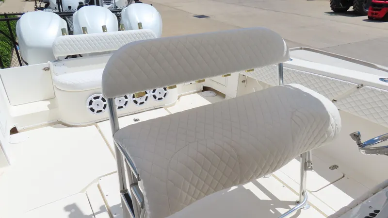 Slide: The Image of 2002 Fountain 38 TE boat interior with white cushioned seating and multiple outboard engines. - 28