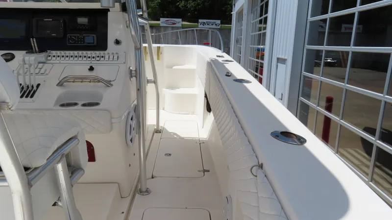 Slide: The Image of 2002 Fountain 38 TE boat interior with helm, seating, and storage compartments. - 29