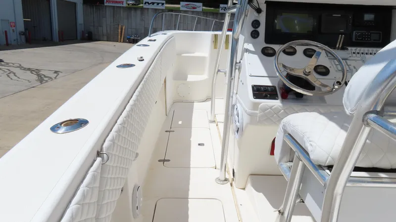 Slide: The Image of 2002 Fountain 38 TE boat interior with steering wheel and seating. - 30