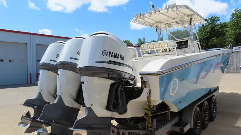 Slide: The Image of 2002 Fountain 38 TE boat with triple Yamaha outboard engines on a trailer. - 4