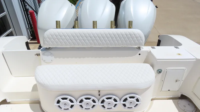 Slide: The Image of 2002 Fountain 38 TE boat with white seating and multiple outboard engines. - 8