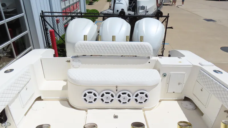 Slide: The Image of 2002 Fountain 38 TE boat with quad outboard engines and white seating. - 9