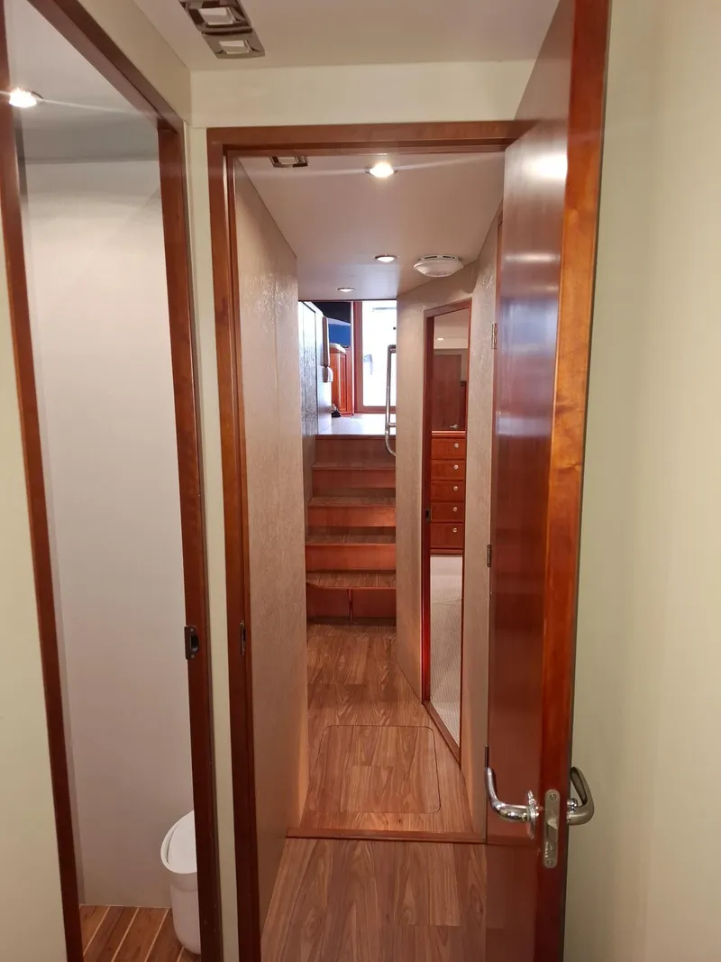 Slide: The Image of Interior hallway of 2007 Bertram 630E yacht with wooden finishes and modern design. - 10