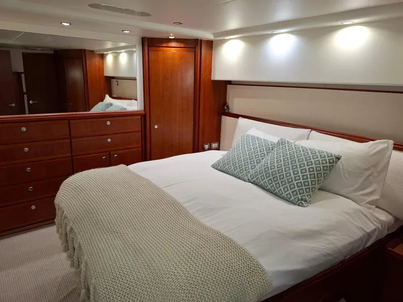 Slide: The Image of Luxurious bedroom interior of 2007 Bertram 630E yacht with elegant wood finish. - 11