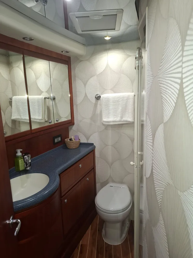 Slide: The Image of Luxurious bathroom in 2007 Bertram 630E yacht with modern fixtures and elegant design. - 16