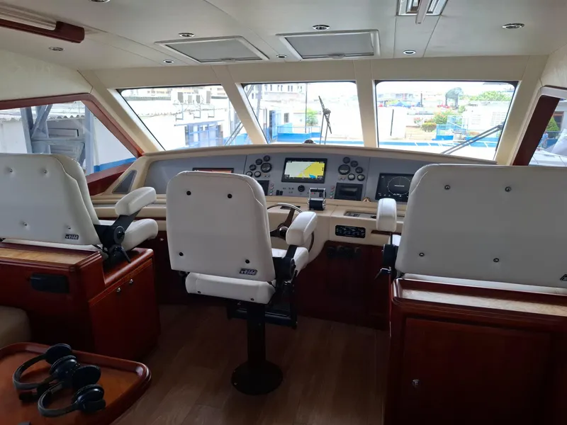 Slide: The Image of 2007 Bertram 630E yacht helm with modern navigation equipment and comfortable seating. - 18