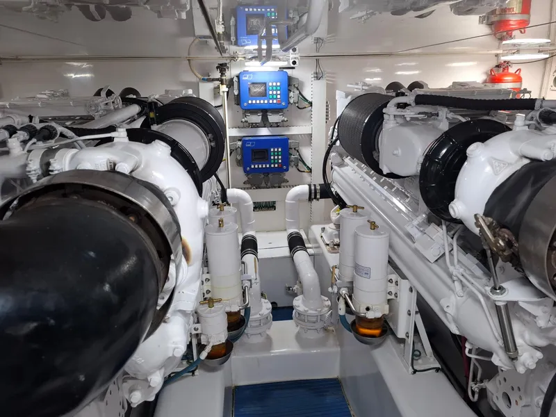 Slide: The Image of Engine room of a 2007 Bertram 630E yacht, featuring dual engines and control panels. - 23
