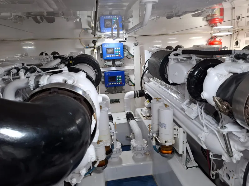 Slide: The Image of Engine room of a 2007 Bertram 630E yacht, featuring dual engines and control panels. - 24