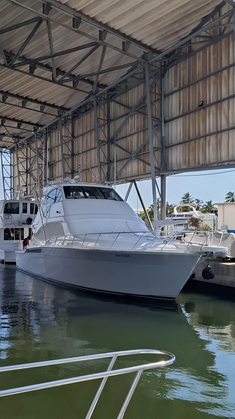 Slide: The Image of 2007 Bertram 630E yacht docked in a covered marina. - 25
