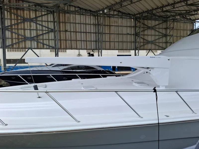 Slide: The Image of 2007 Bertram 630E yacht under a metal roof, showcasing sleek design and modern features. - 28