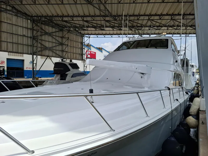 Slide: The Image of 2007 Bertram 630E yacht docked in a covered marina. - 29