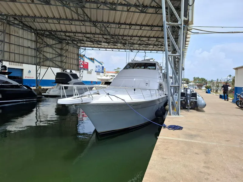 Slide: The Image of 2007 Bertram 630E yacht docked in a covered marina, side view. - 30