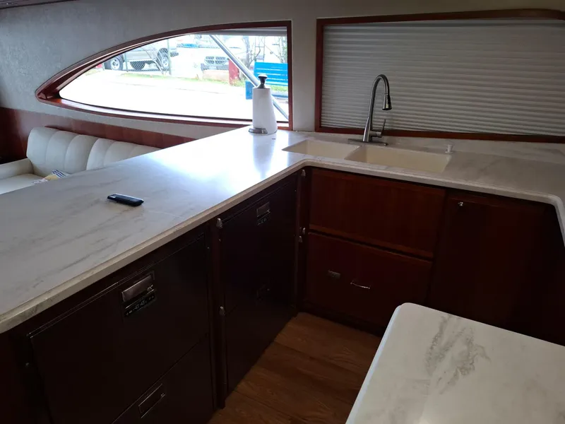 Slide: The Image of 2007 Bertram 630E yacht interior with modern kitchen and sleek countertops. - 5