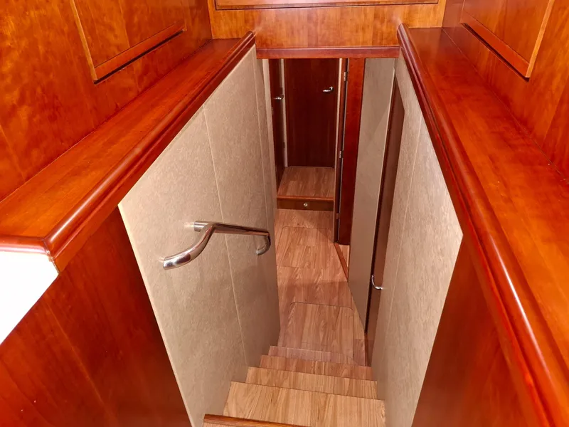 Slide: The Image of Staircase with wooden finish inside a 2007 Bertram 630E yacht. - 8