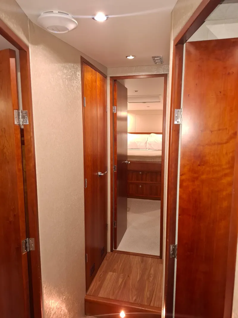 Slide: The Image of Interior hallway of a 2007 Bertram 630E yacht with wooden doors and flooring. - 9
