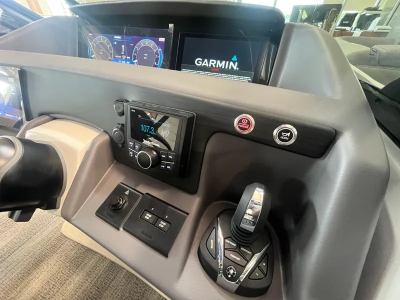 Slide: The Image of 2025 Bennington 27RSBWAT2 boat dashboard with Garmin display and control panel. - 11