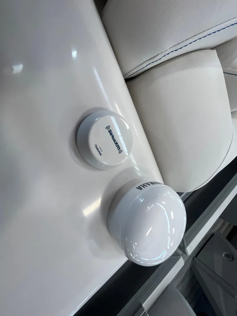 Slide: The Image of 2025 Bennington 27RSBWAT2 boat interior with white seating and branded accessories. - 15