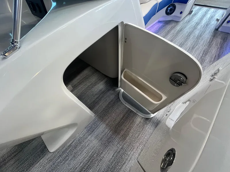 Slide: The Image of Open storage compartment on 2025 Bennington 27RSBWAT2 boat, featuring sleek interior design. - 16