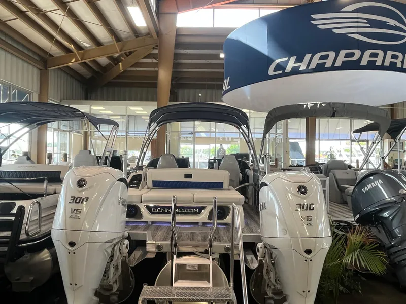 Slide: The Image of 2025 Bennington 27RSBWAT2 boat with dual engines displayed indoors. - 2