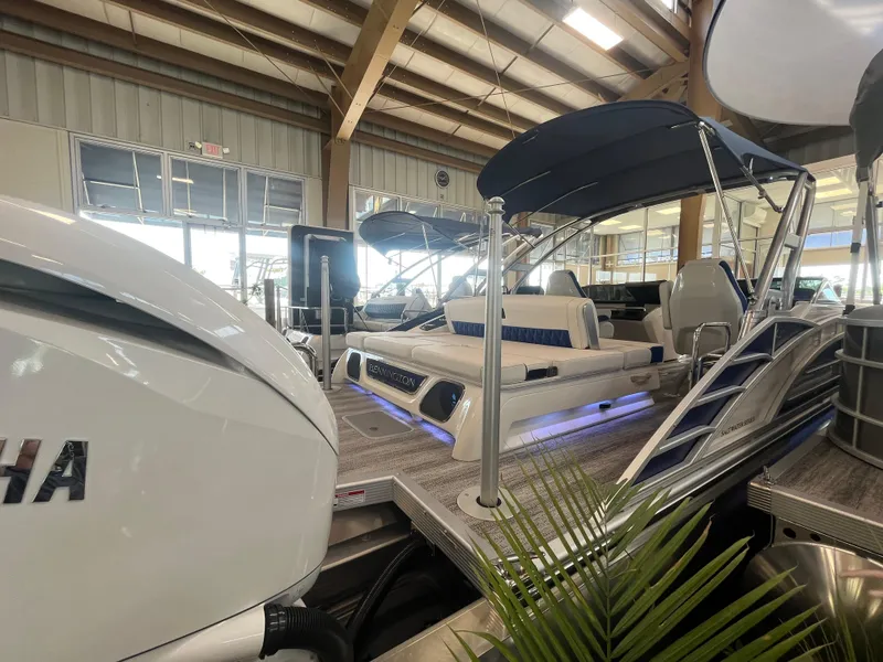 Slide: The Image of 2025 Bennington 27RSBWAT2 pontoon boat displayed indoors with Yamaha engine. - 20