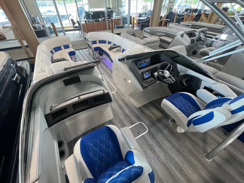 Slide: The Image of Luxurious 2025 Bennington 27RSBWAT2 pontoon boat interior with blue and white seating. - 5