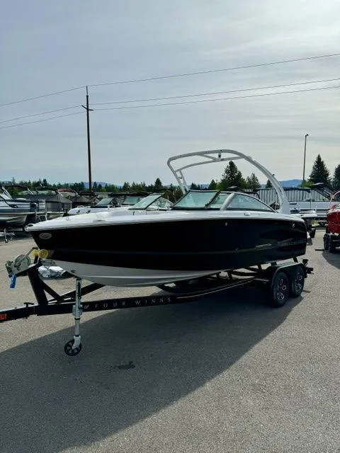 Slide: The Image of 2023 Four Winns H2 boat on trailer in outdoor setting. - 2