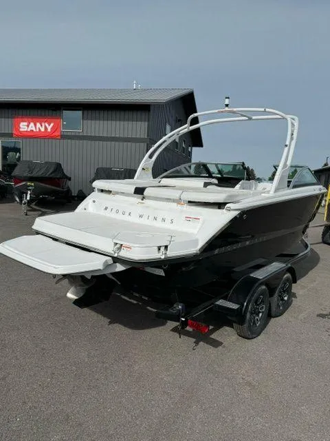 Slide: The Image of 2023 Four Winns H2 boat on trailer, displayed outdoors. - 3