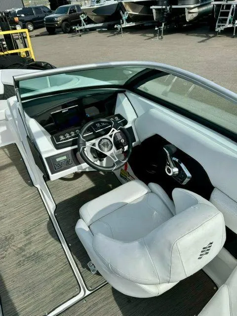 Slide: The Image of 2023 Four Winns H2 boat cockpit with modern steering and controls. - 4