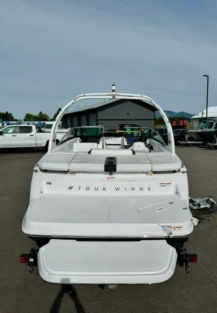 Slide: The Image of 2023 Four Winns H2 boat, rear view, parked outdoors. - 5