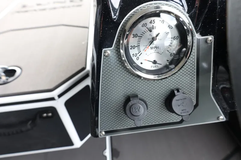 Slide: The Image of 2025 Lund 1875 Renegade SS dashboard with speedometer and 12V power outlets. - 17