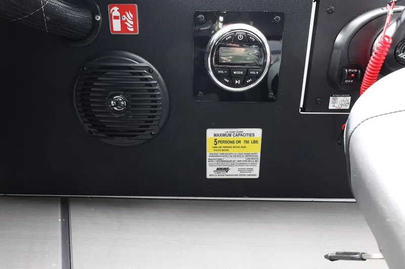 Slide: The Image of Control panel of 2025 Lund 1875 Renegade SS boat with speaker and capacity label. - 18
