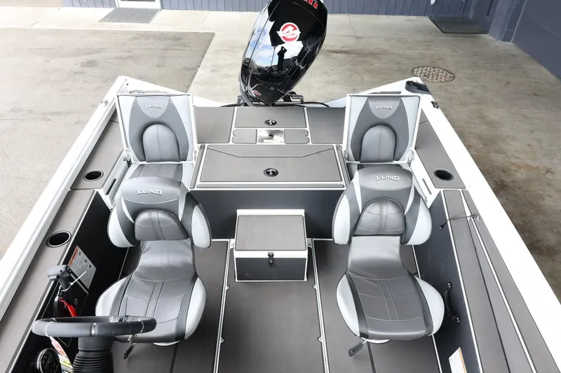 Slide: The Image of 2025 Lund 1875 Renegade SS boat interior with four gray seats and a sleek design. - 21