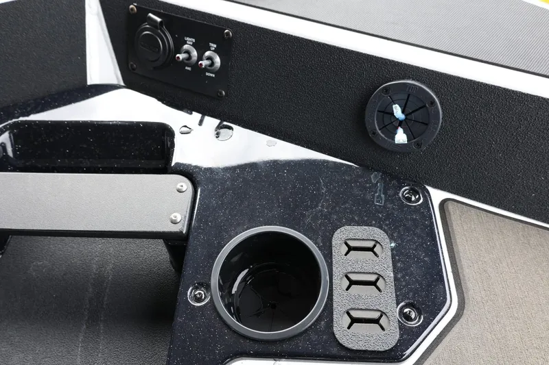 Slide: The Image of 2025 Lund 1875 Renegade SS boat dashboard with controls and cup holder. - 32