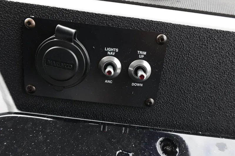 Slide: The Image of Control panel of 2025 Lund 1875 Renegade SS boat with switches for lights and trim. - 33