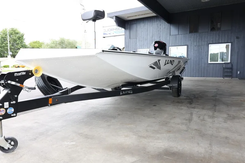 Slide: The Image of 2025 Lund 1875 Renegade SS boat on trailer in covered area. - 4