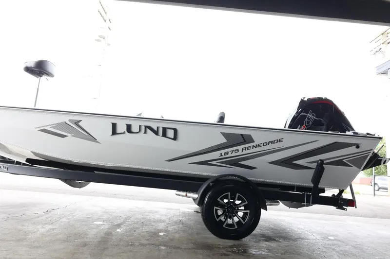 Slide: The Image of 2025 Lund 1875 Renegade SS boat on trailer, side view, in a garage setting. - 5