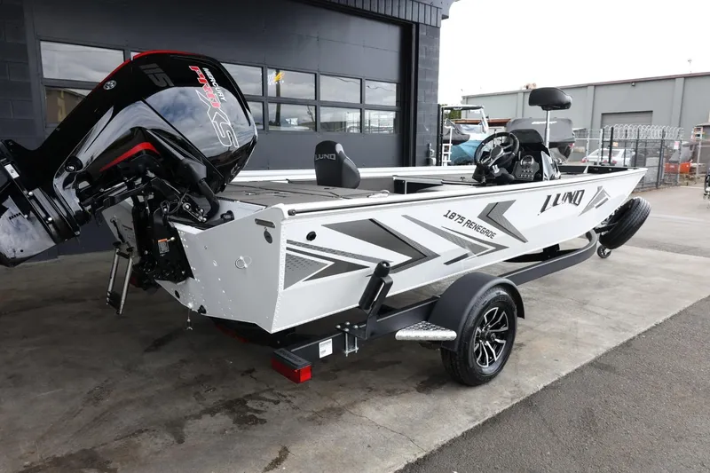Slide: The Image of 2025 Lund 1875 Renegade SS boat with outboard motor, parked on a trailer. - 9