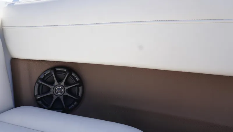 Slide: The Image of Interior of 2014 Cobalt 210 boat with speaker and white upholstery. - 19