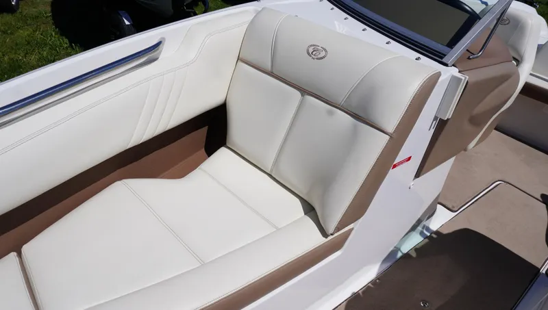 Slide: The Image of Luxurious seating in a 2014 Cobalt 210 boat with white and beige upholstery. - 25