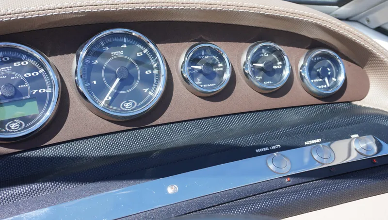 Slide: The Image of Dashboard of a 2014 Cobalt 210 boat with multiple gauges and controls. - 28