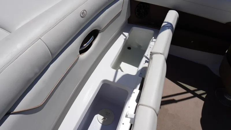 Slide: The Image of 2014 Cobalt 210 boat interior with open storage compartment and cushioned seating. - 31