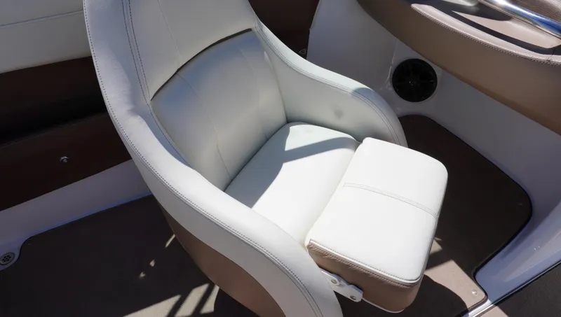 Slide: The Image of 2014 Cobalt 210 boat seat with white upholstery and armrest. - 33